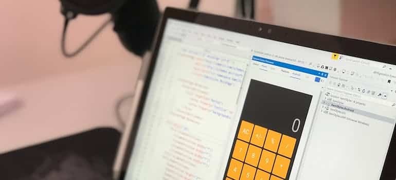 A calculator open on a laptop, calculating software development posts.